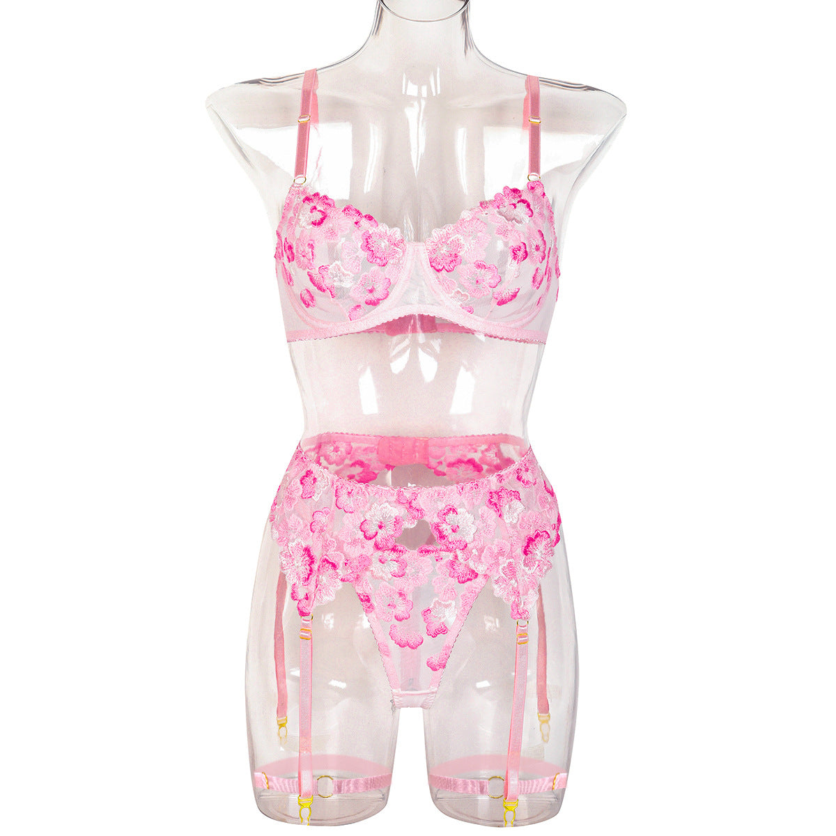 “Close-up of heavy floral embroidery and sheer fabric on erotic three-piece lingerie set”