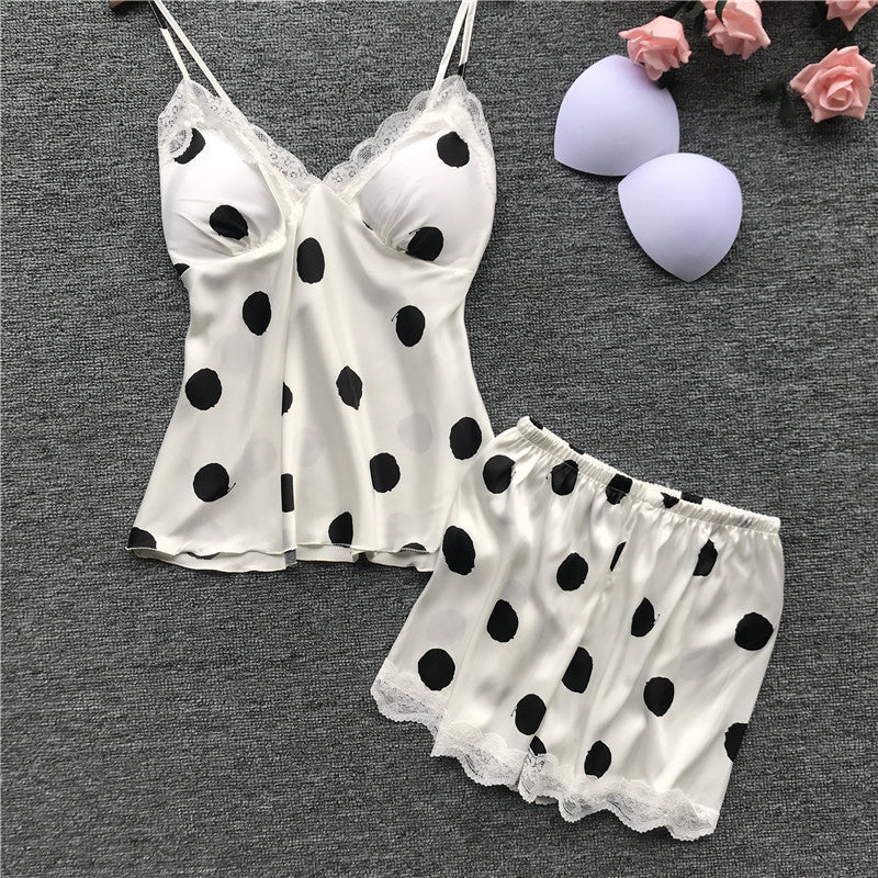 White satin nightgown with black polka dots on a gray background
