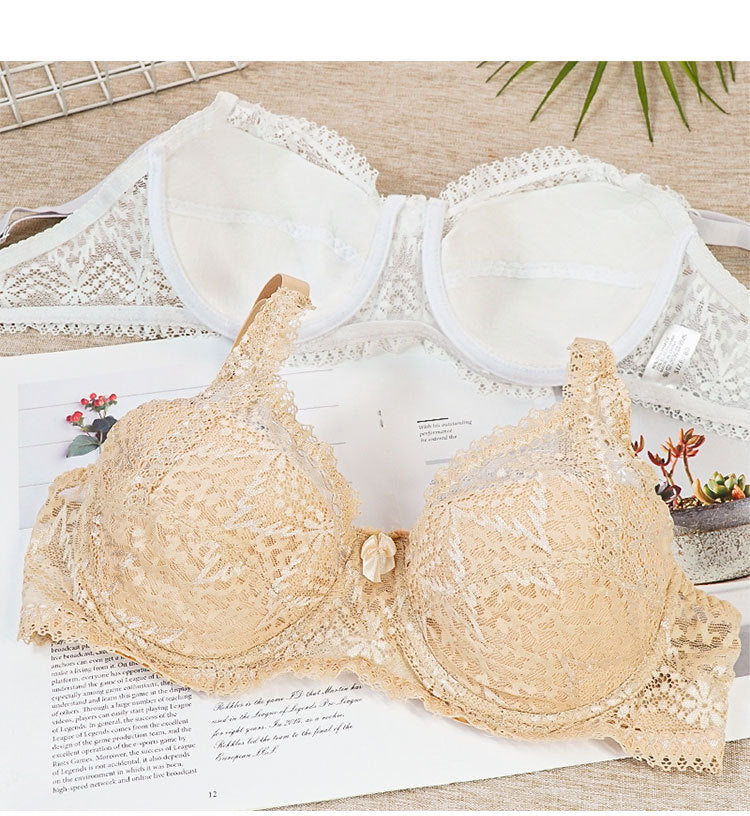 Beige lace bra on a wooden surface with a magazine underneath