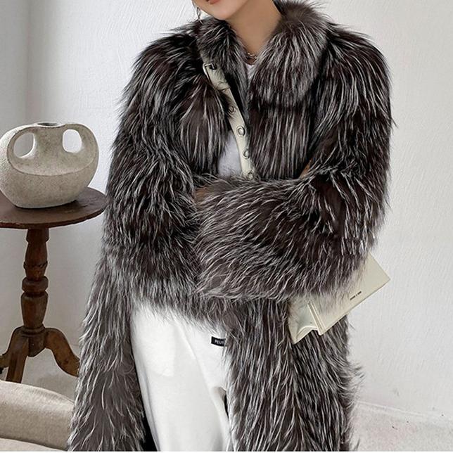Person wearing a fur coat with a neutral background