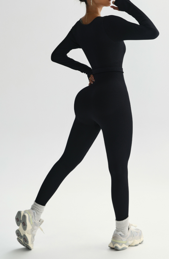 Person wearing a black athletic outfit on a white background