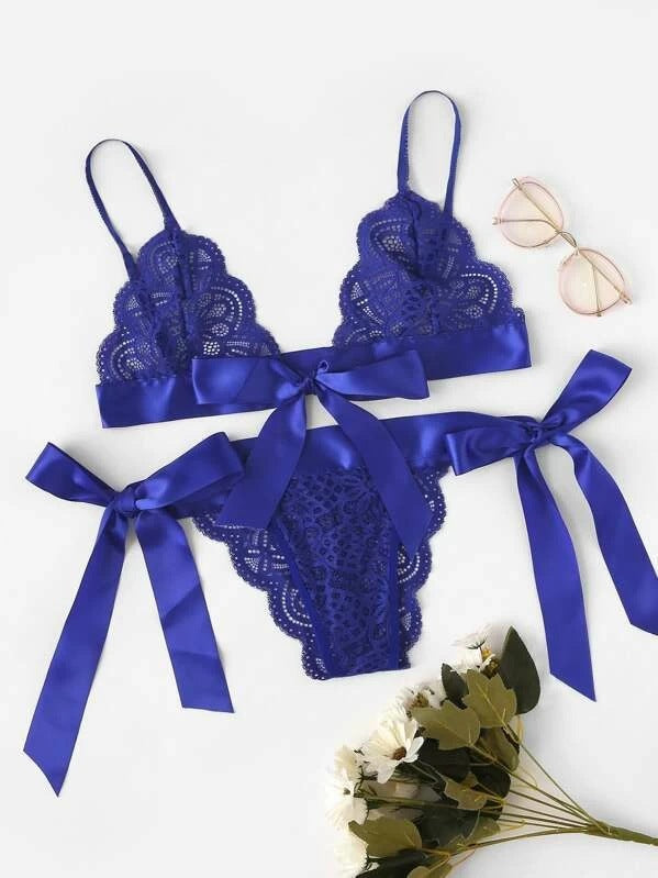Blue lace lingerie set with satin ribbons on a white background