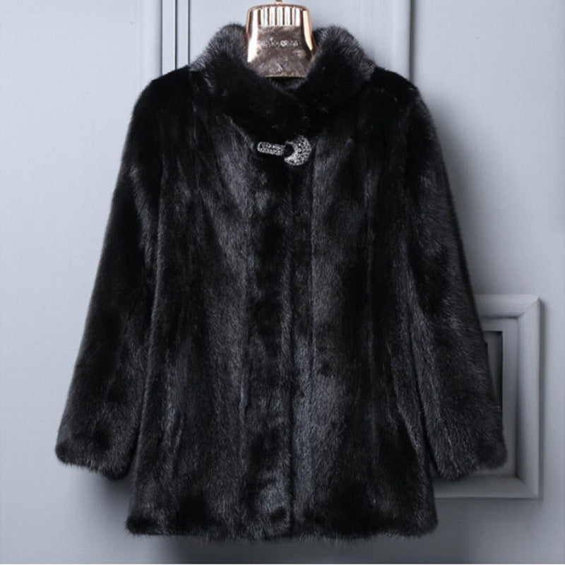 Black fur coat on a hanger against a gray background