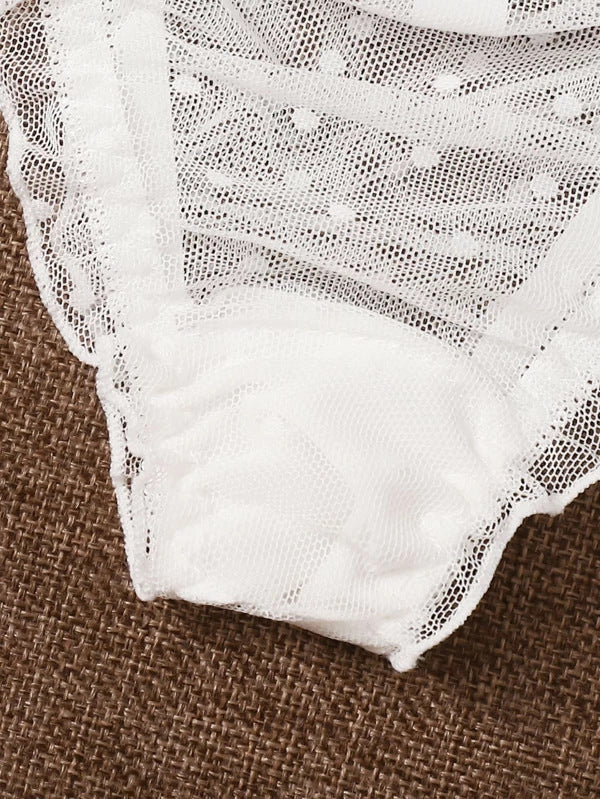 Close-up of white lace fabric on a brown textured background
