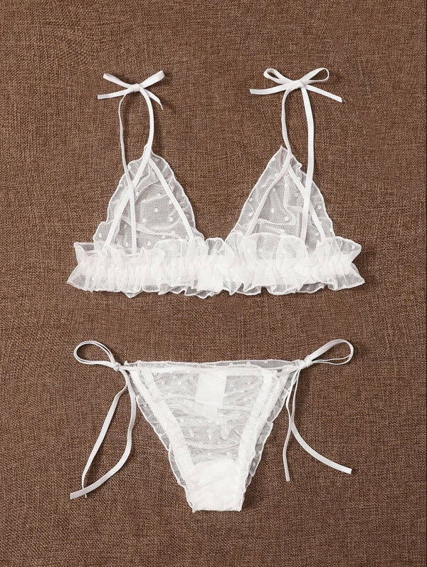 White lace bikini set on a brown fabric background