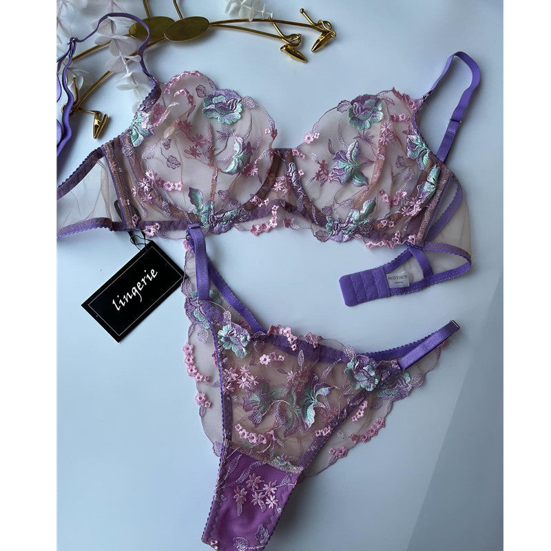 Plus size woman wearing purple mesh embroidered lingerie set front view