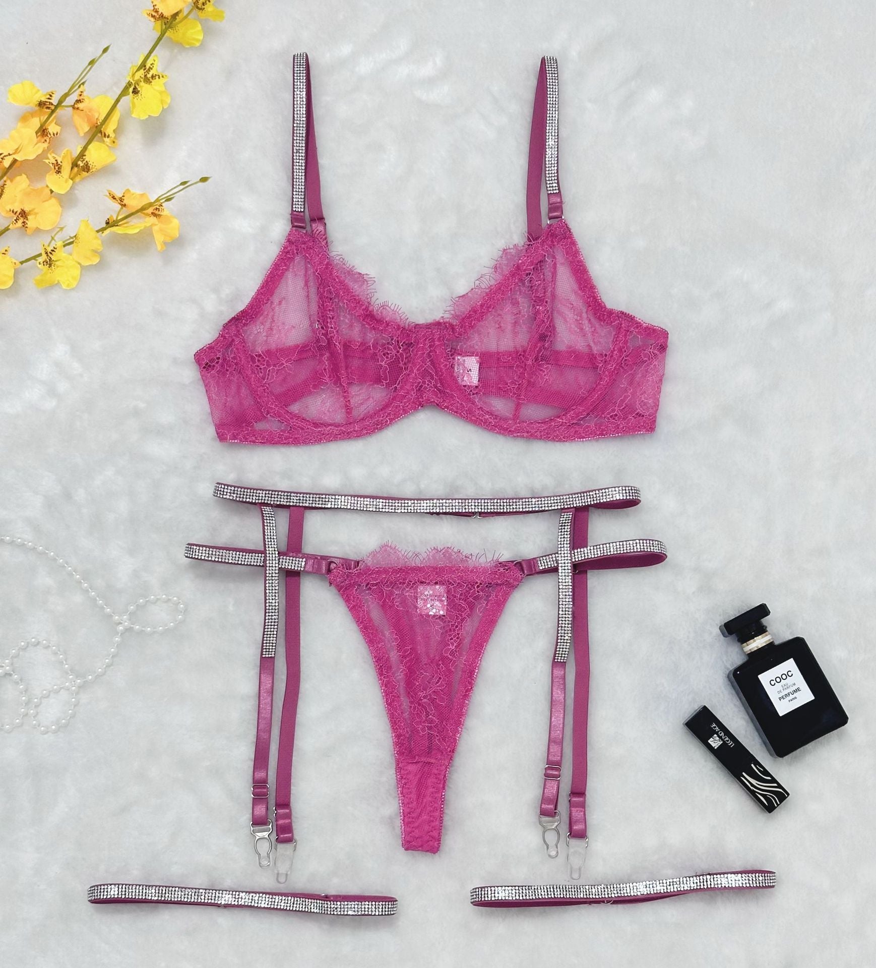 “Close-up of rhinestone details on lace trim transparent thong garter belt lingerie set”