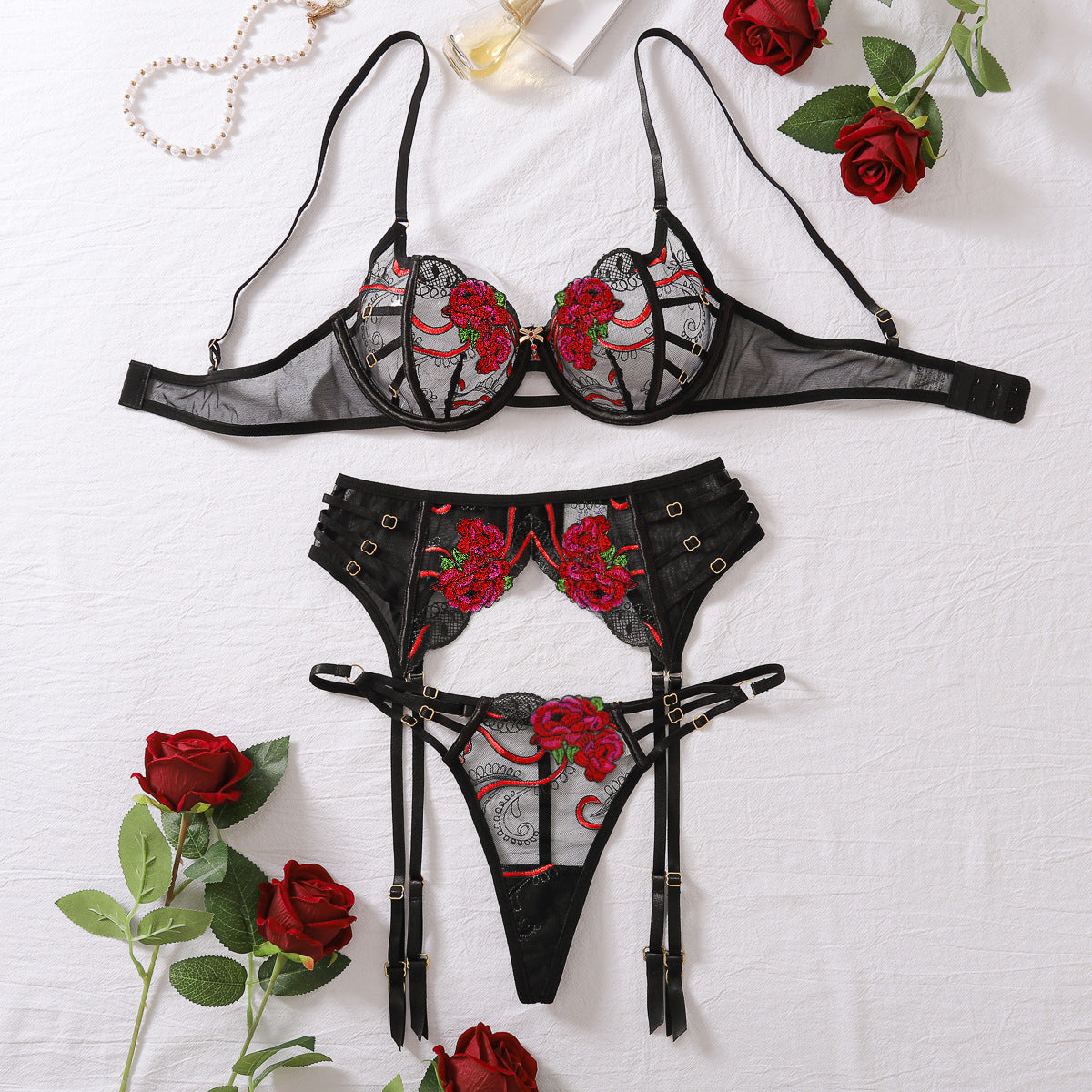 “Close-up of gathering bra and detailed embroidery on erotic three-piece lingerie”