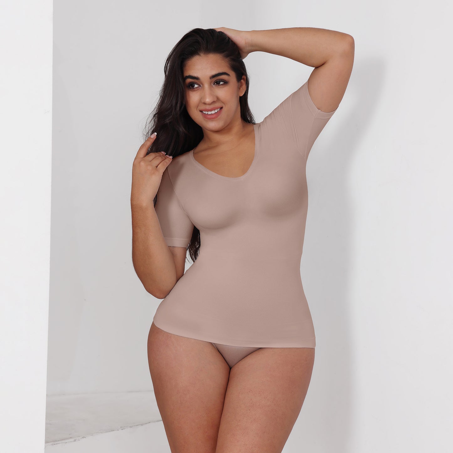 Plus size woman wearing V-neck waist-cinching T-shirt