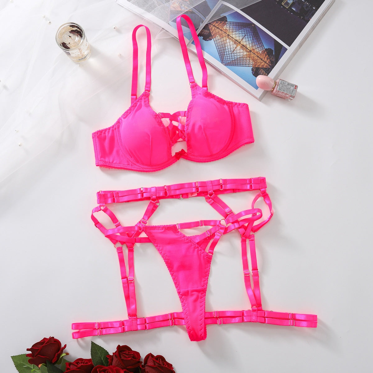 “Front view of see-through strappy bra thong lingerie set with garter belt”