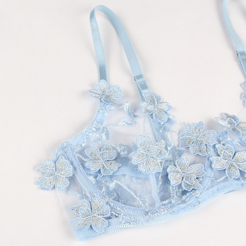 Light blue bra with floral lace details on a white background