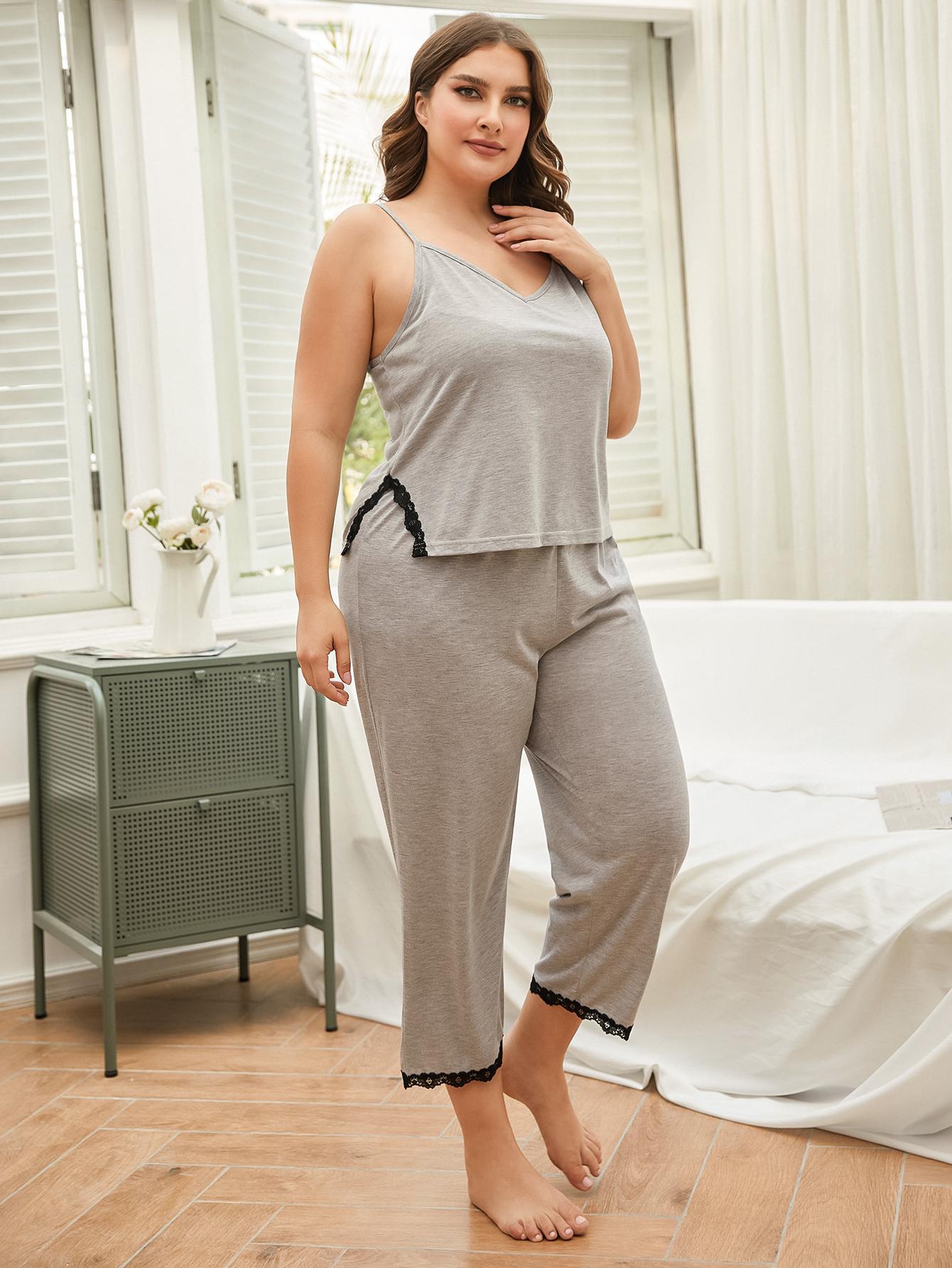 Woman wearing a gray pajama set in a bedroom.