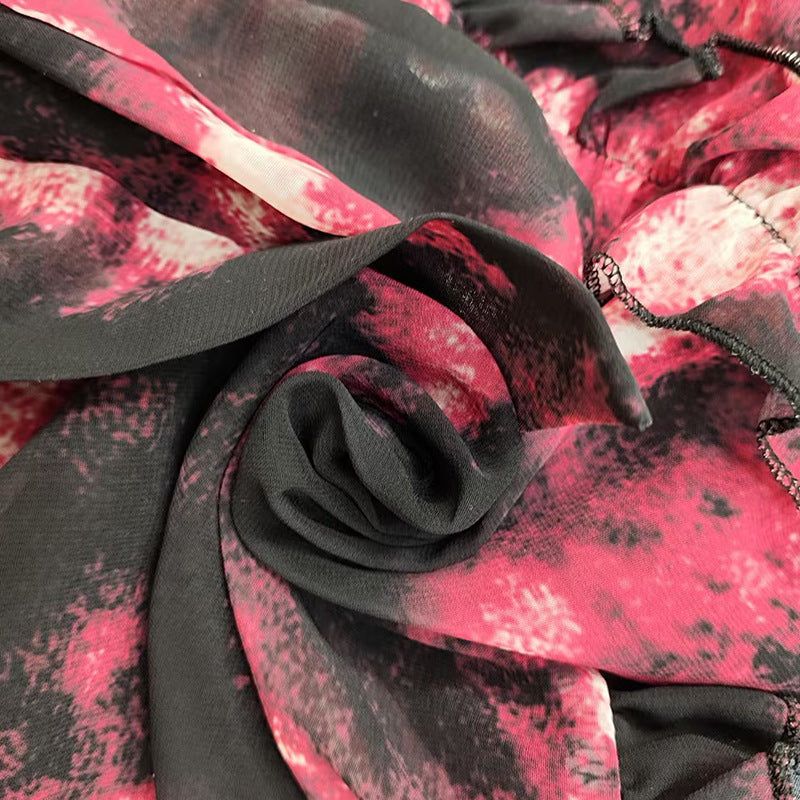 Close-up of pink and black patterned fabric with a rose design.
