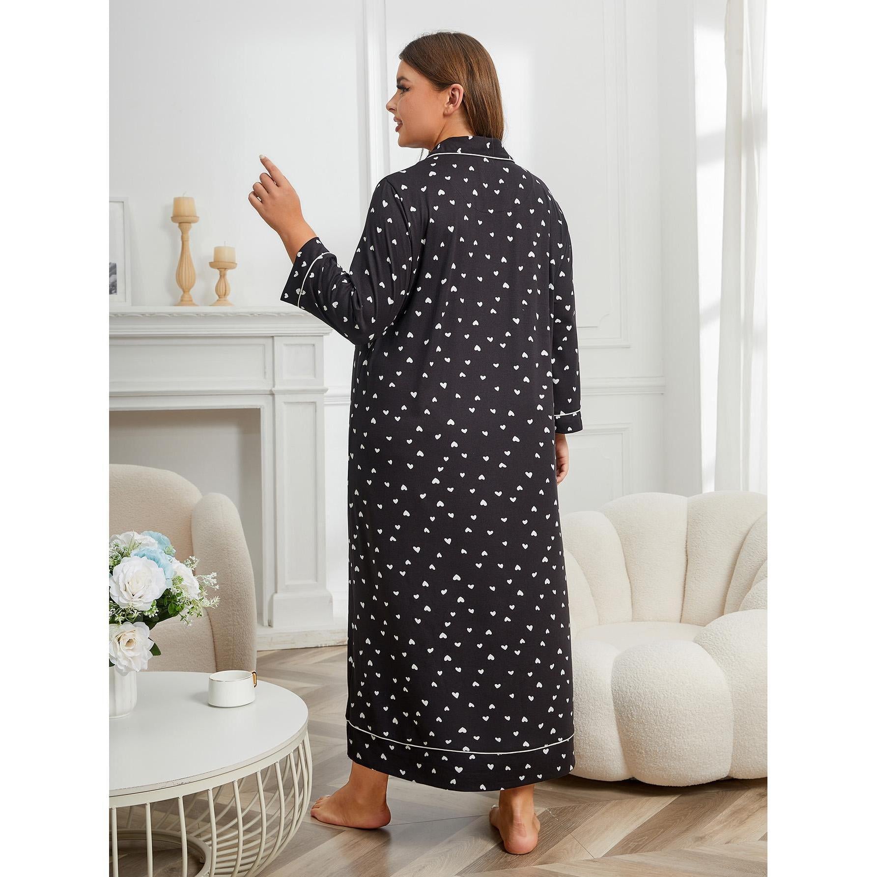 Woman wearing a black robe with white patterns in a living room setting.