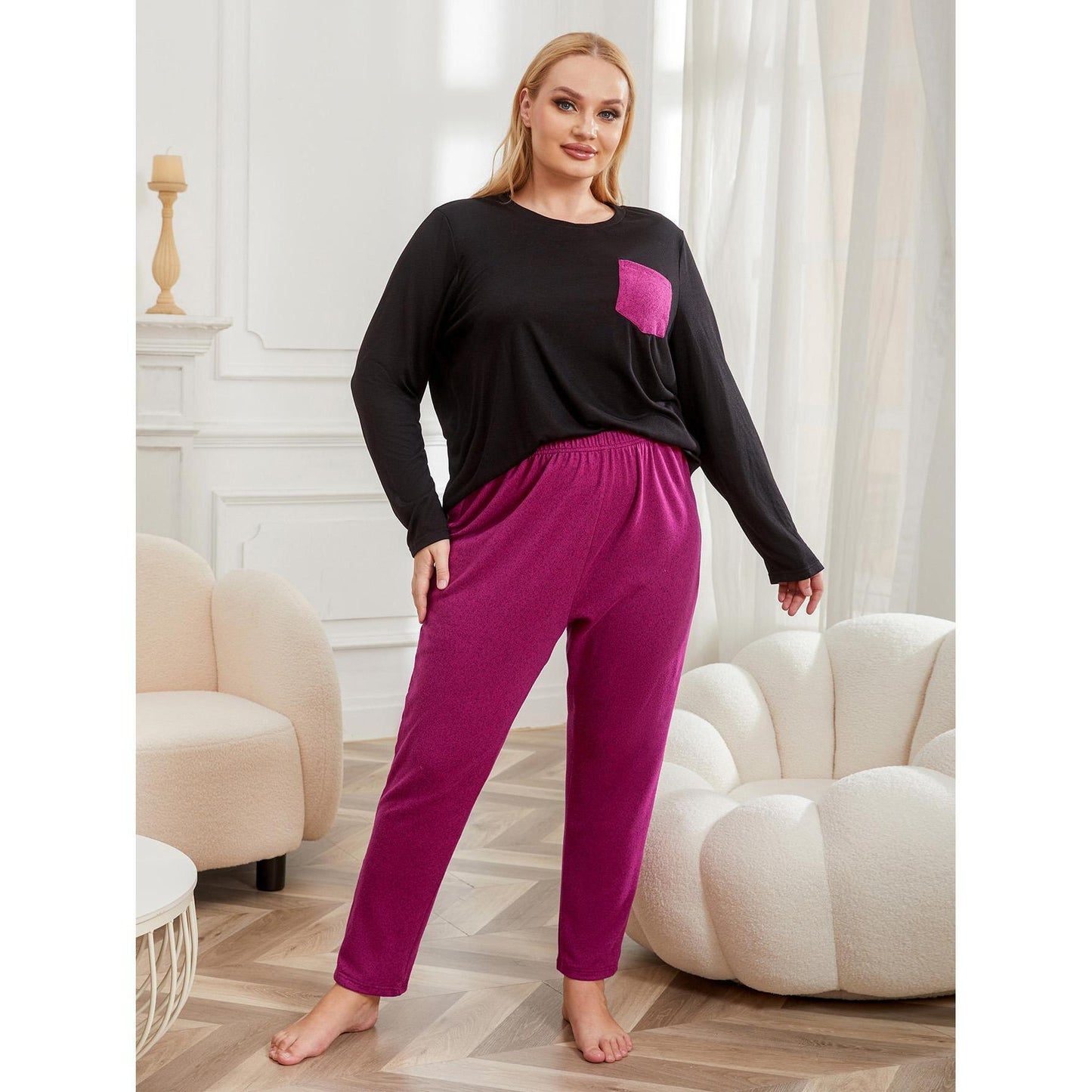 Plus size woman wearing solid color long-sleeve top and matching pajama pants