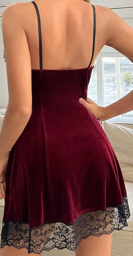 Burgundy nightgown with lace hem worn by a person, sitting on a couch.