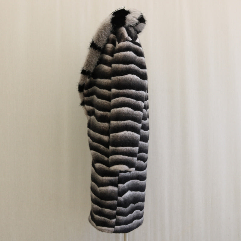 Striped fur coat on a mannequin against a plain background