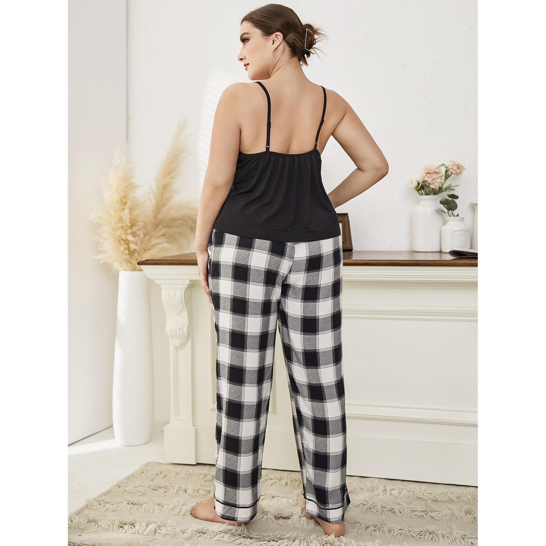 Woman wearing a black tank top and plaid pants in a room with decorative elements.
