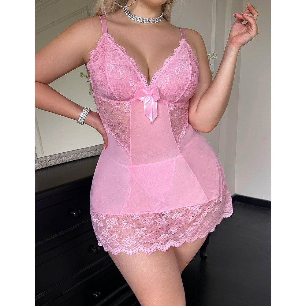 Person wearing a pink lace lingerie set in a room setting.
