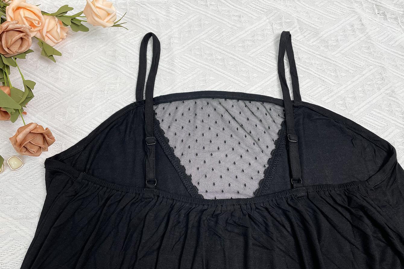 Black lace top on a textured surface with flowers around