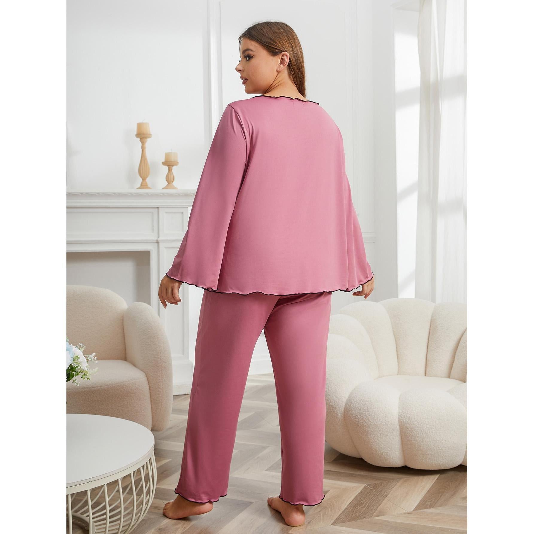 Woman wearing pink pajamas in a cozy living room.