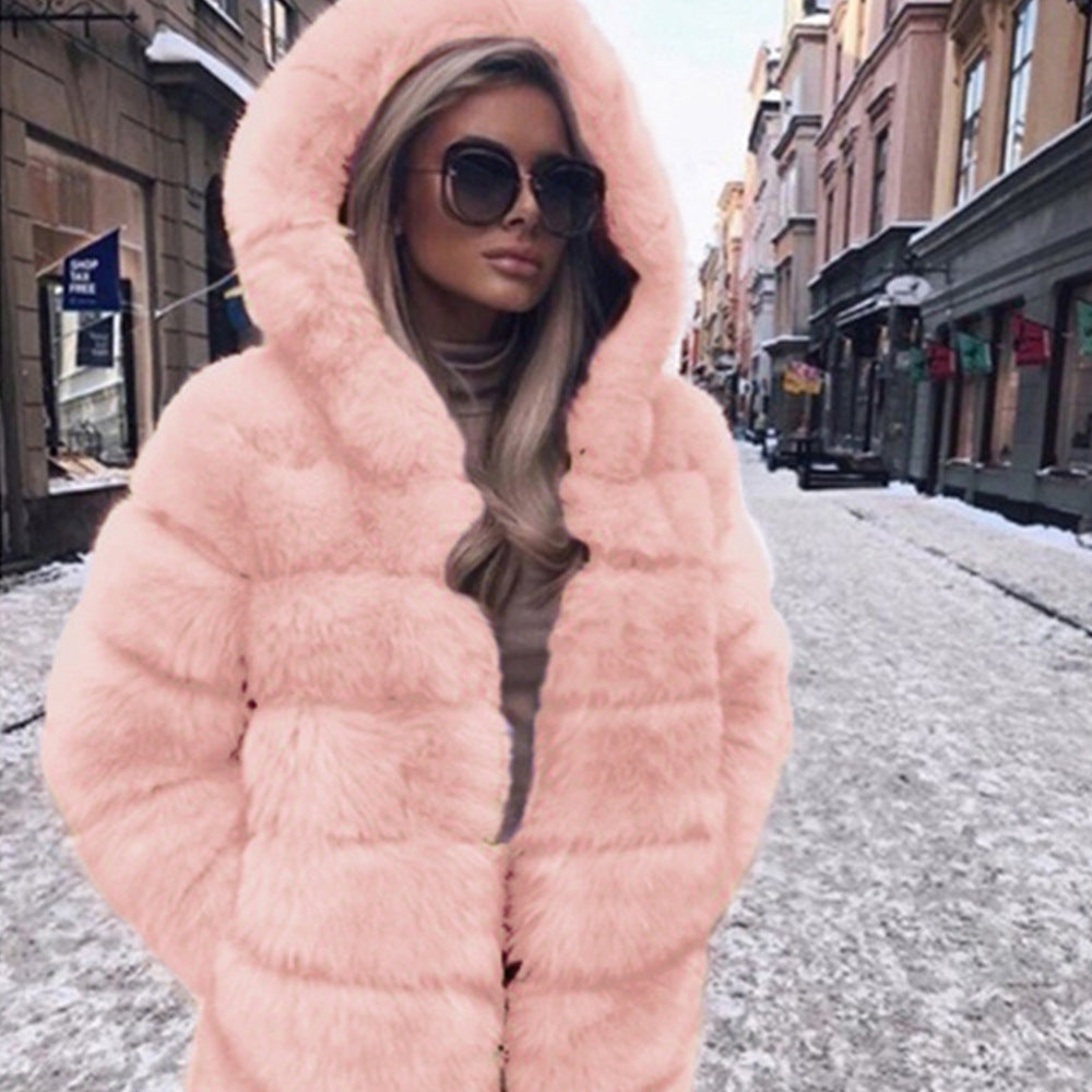 Person wearing a pink fur coat on a city street.
