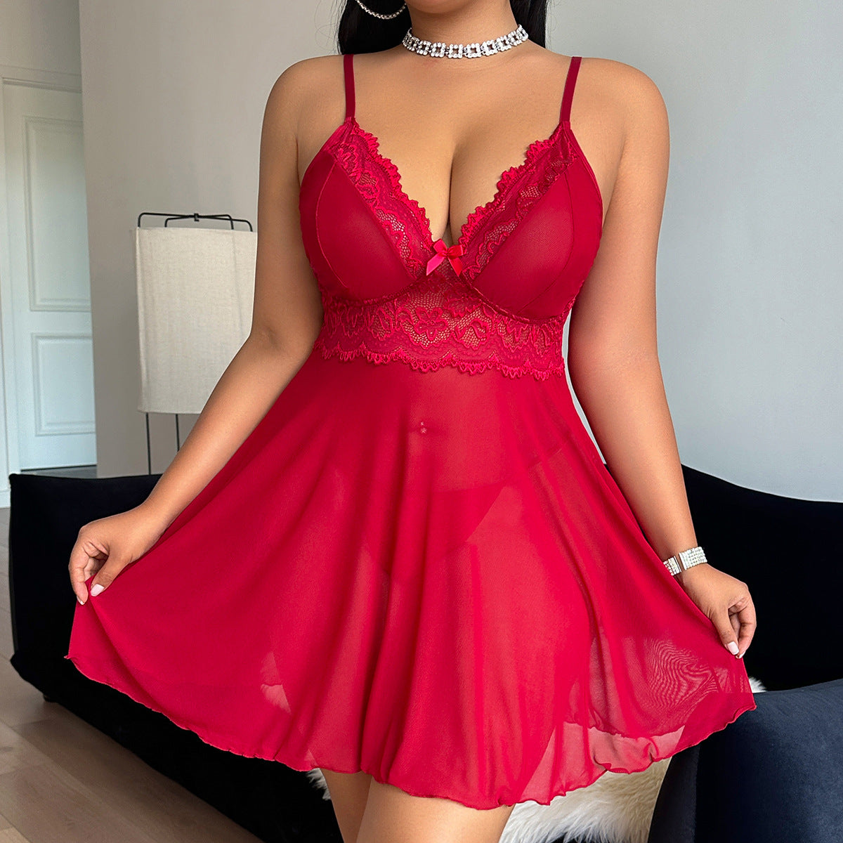 Red lace lingerie set worn by a model in a room setting.