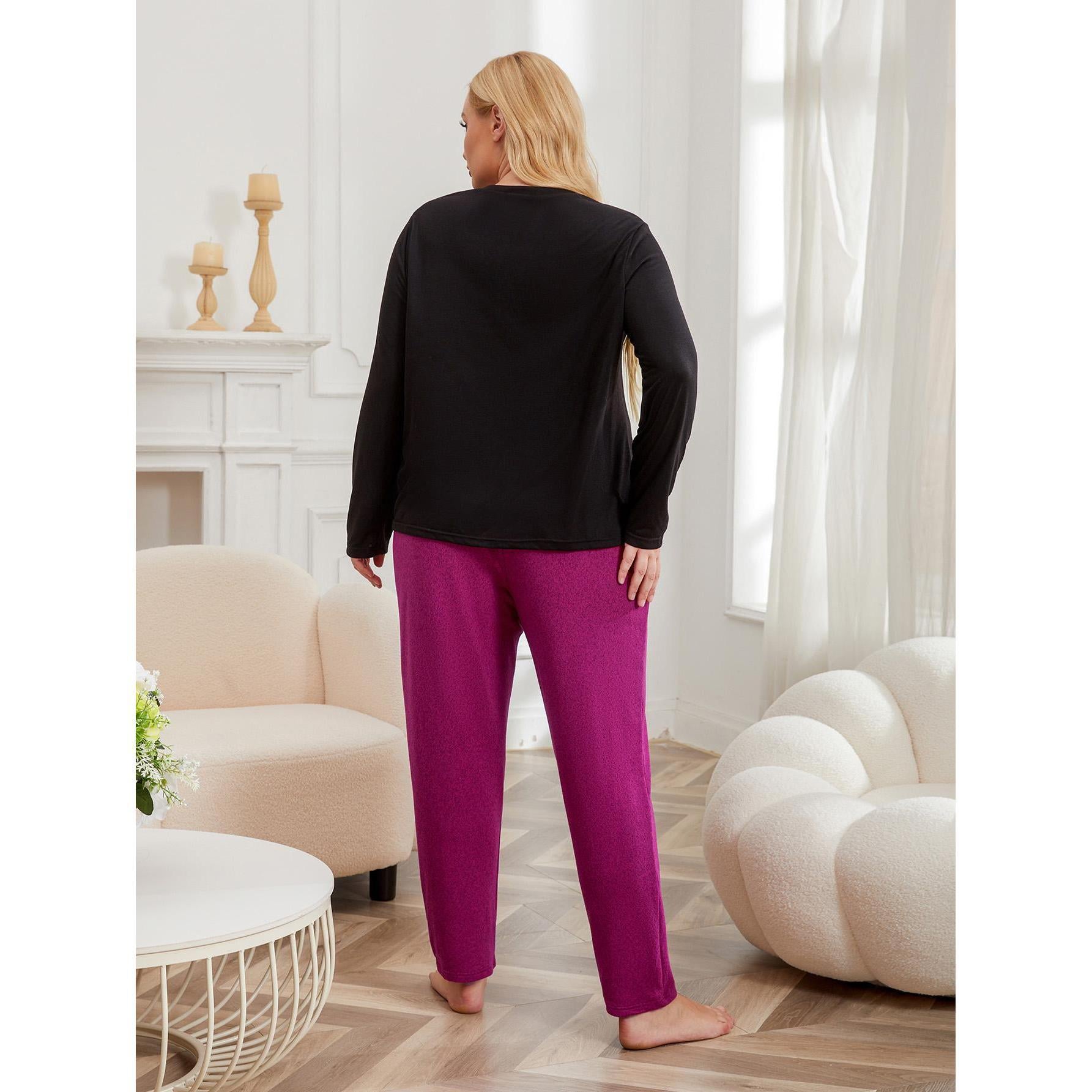 Woman wearing a black top and pink pants in a living room setting