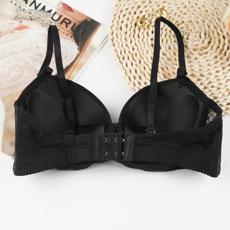 Black bra on a white background with a magazine and woven basket in the background