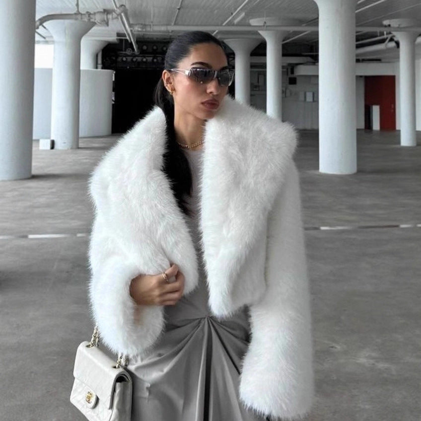 Woman wearing a white fur coat in an indoor setting