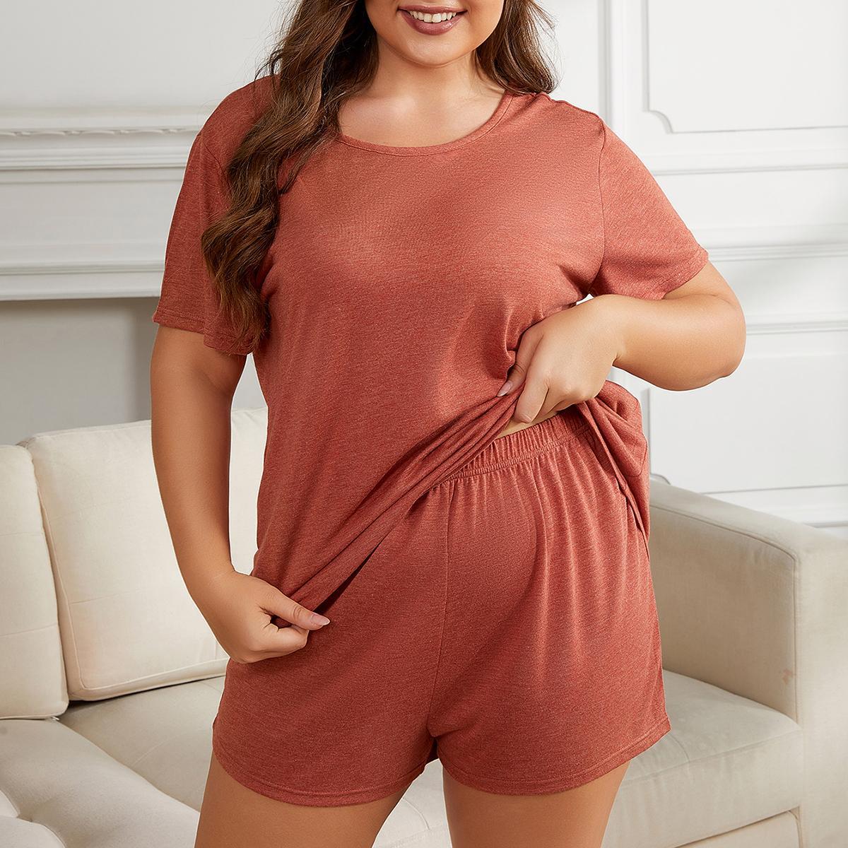 Woman wearing a rust-colored pajama set in a cozy living room.