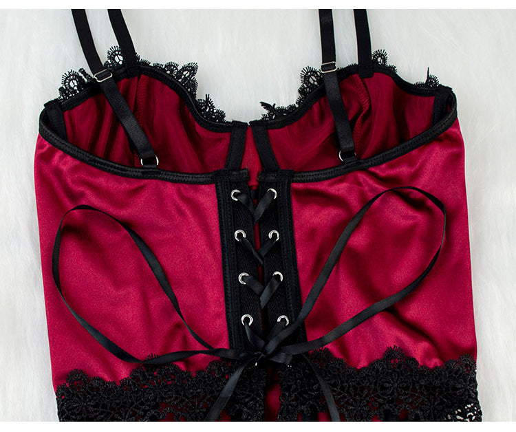 Red lingerie with black lace trim and straps on a white background