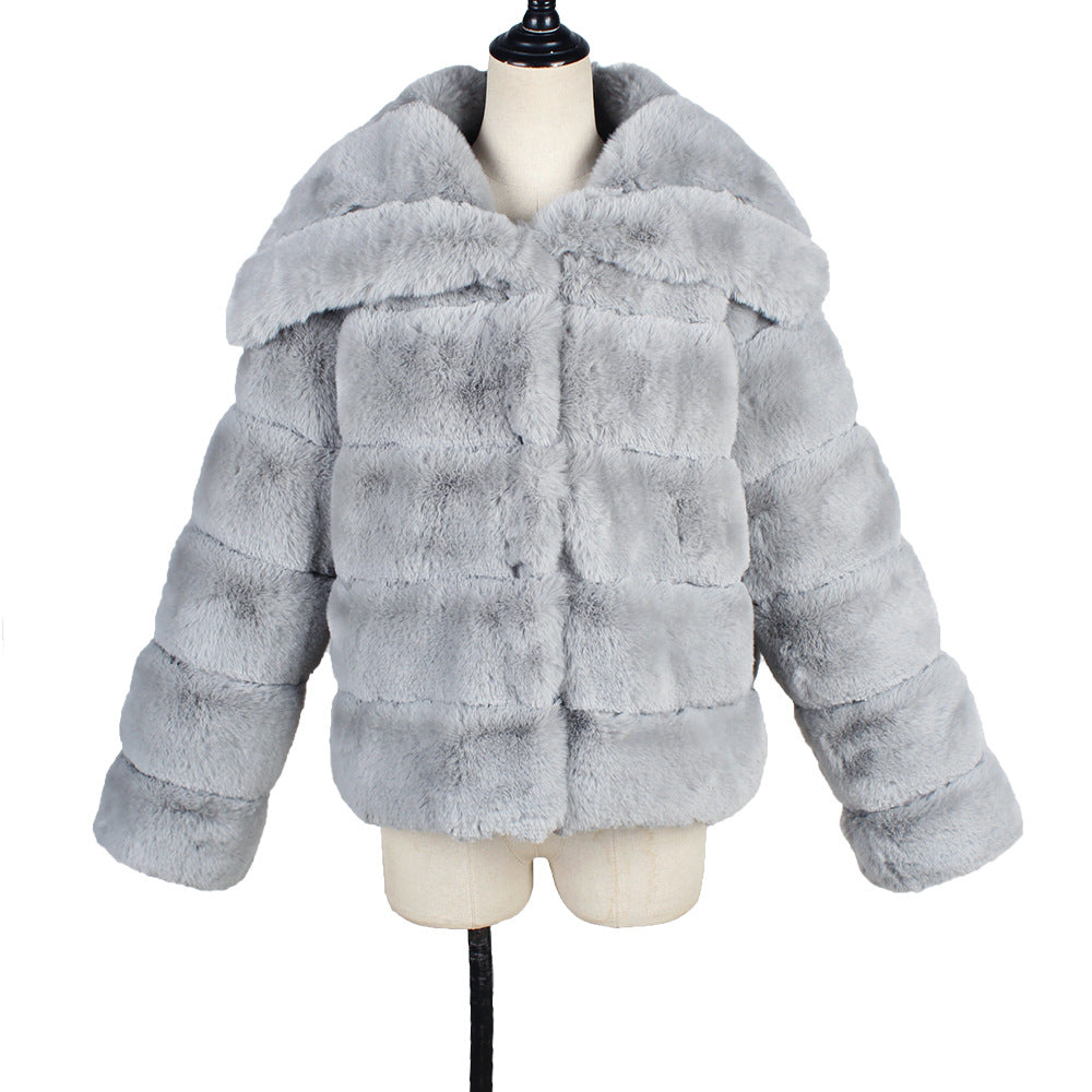 Gray fur coat on a mannequin against a white background