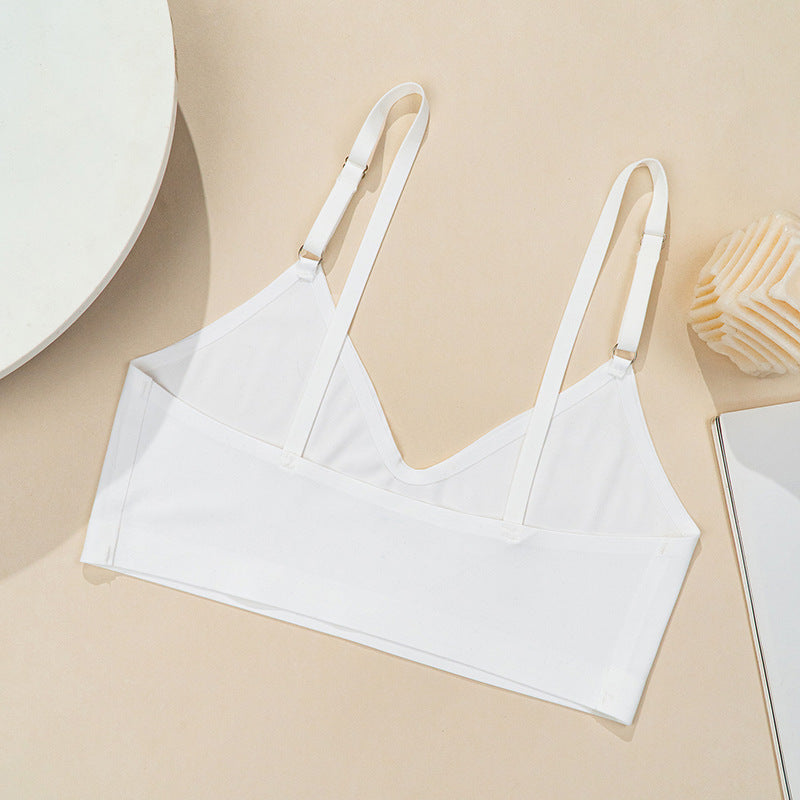 White bralette on a beige surface with minimal background