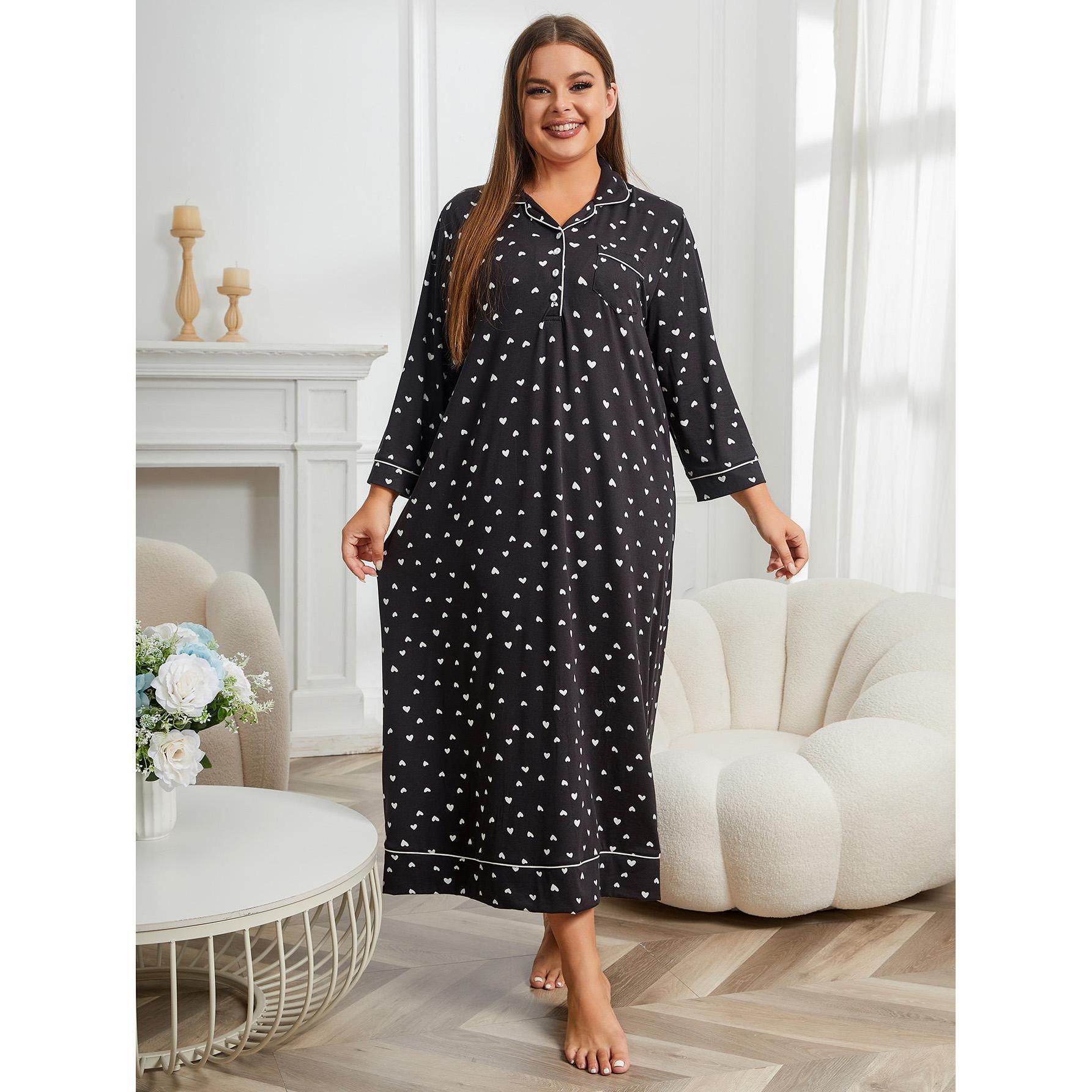Woman wearing a black nightgown with white patterns in a cozy living room.