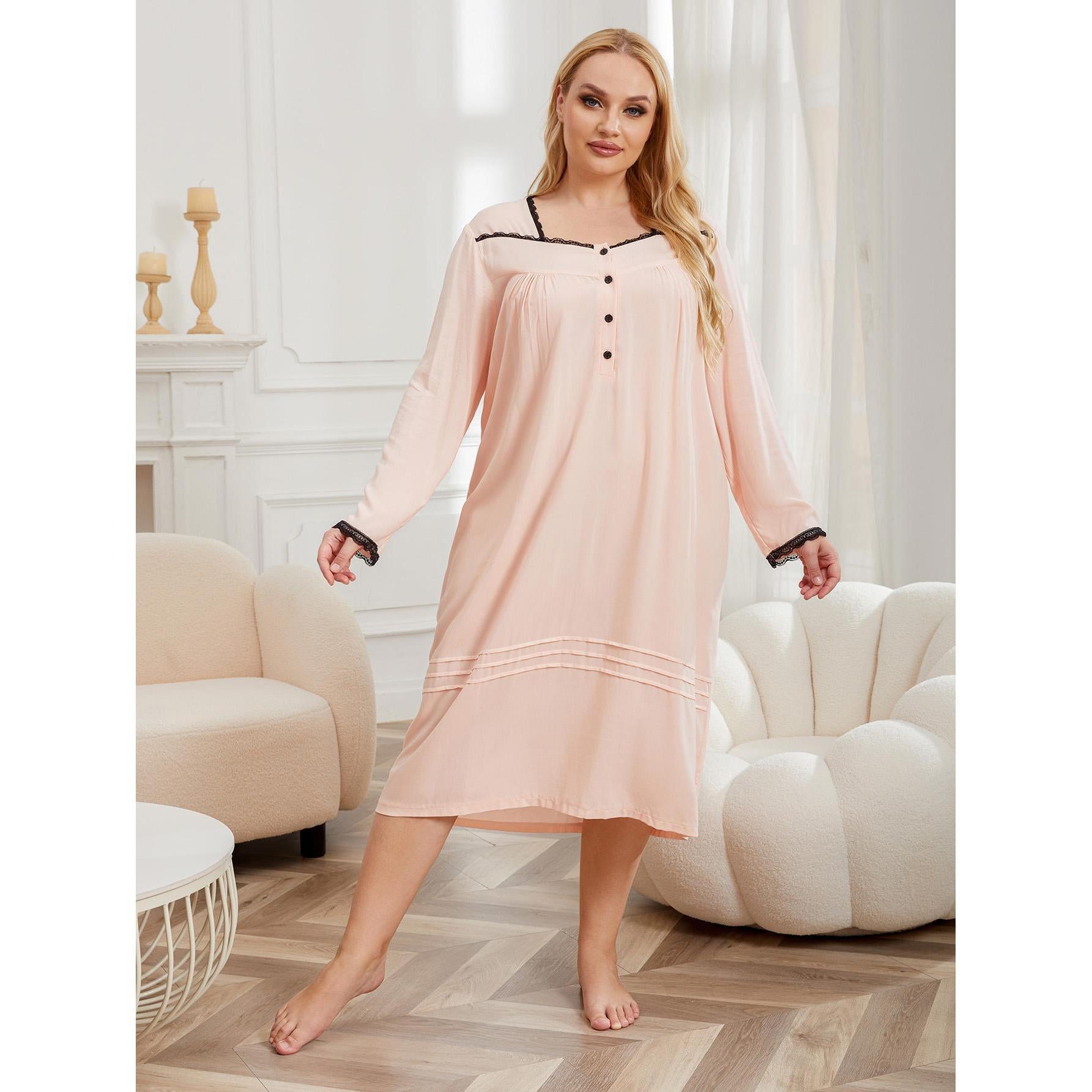 Woman wearing a pink nightgown in a stylish room with white walls and furniture.