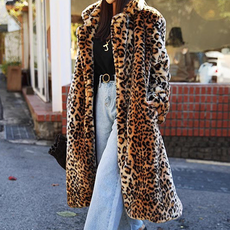 Person wearing a leopard print coat on a street.