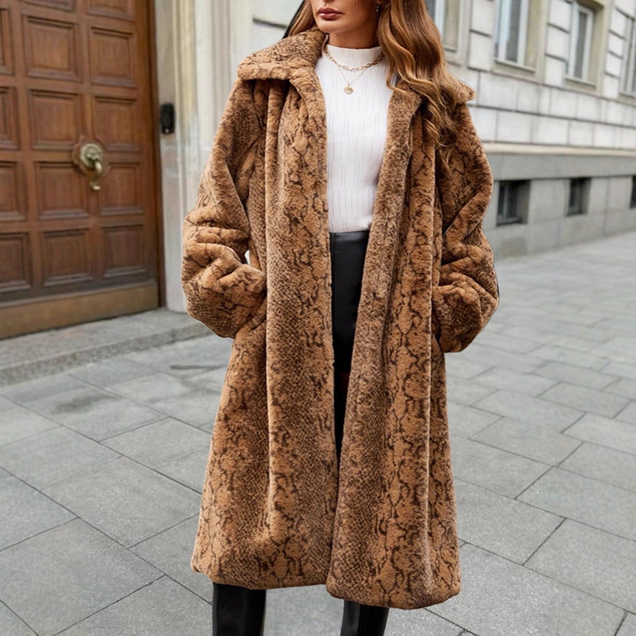 Person wearing a brown textured coat on a city street.