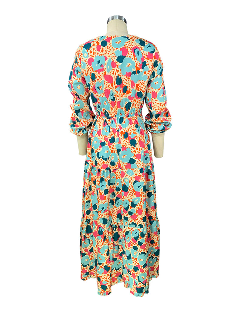 Colorful floral dress on a mannequin against a white background