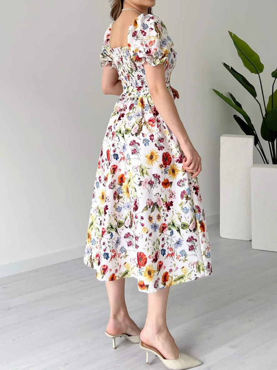 Woman wearing a floral dress in a minimal indoor setting