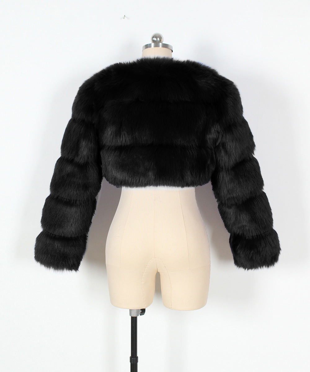 Black fur jacket on a mannequin against a white background
