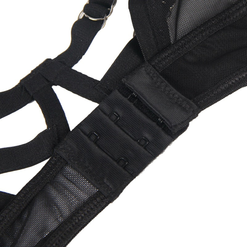Close-up of a black harness with straps on a white background