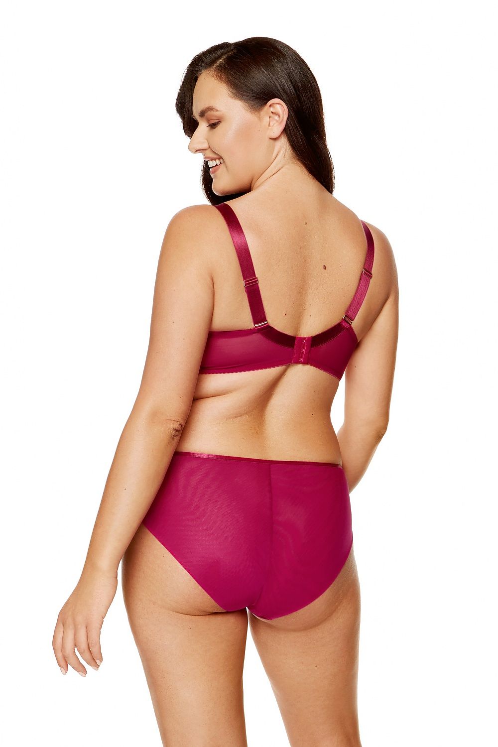 “Close-up of glittering embroidery and decorative detail between cups on fuchsia bra”
