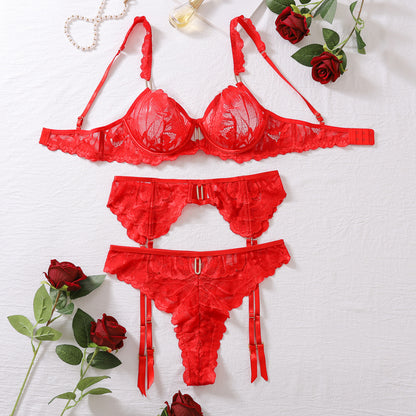“Close-up of French lace detailing on bra, thong, and garter belt three-piece set”