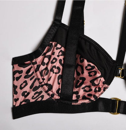 “Close-up of leopard print stitching and buckle accents on sexy lingerie set”