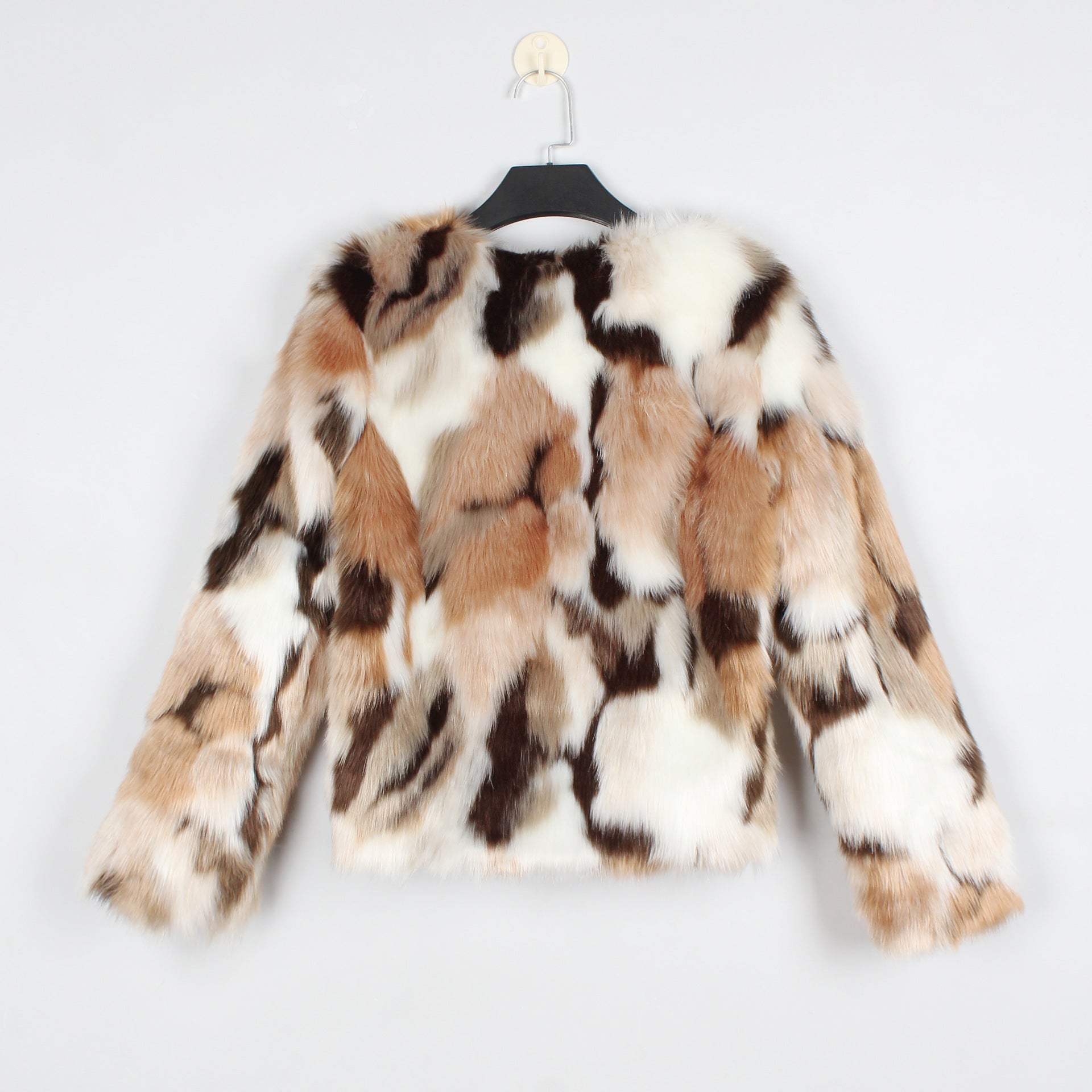 Multicolored fur coat on a hanger against a light gray background