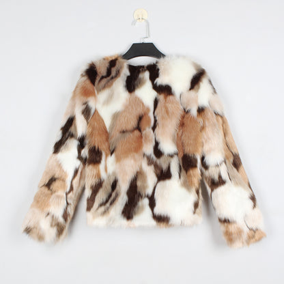 Multicolored fur coat on a hanger against a light gray background