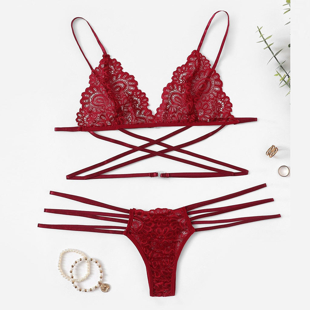 Red lace lingerie set on a white background with jewelry.