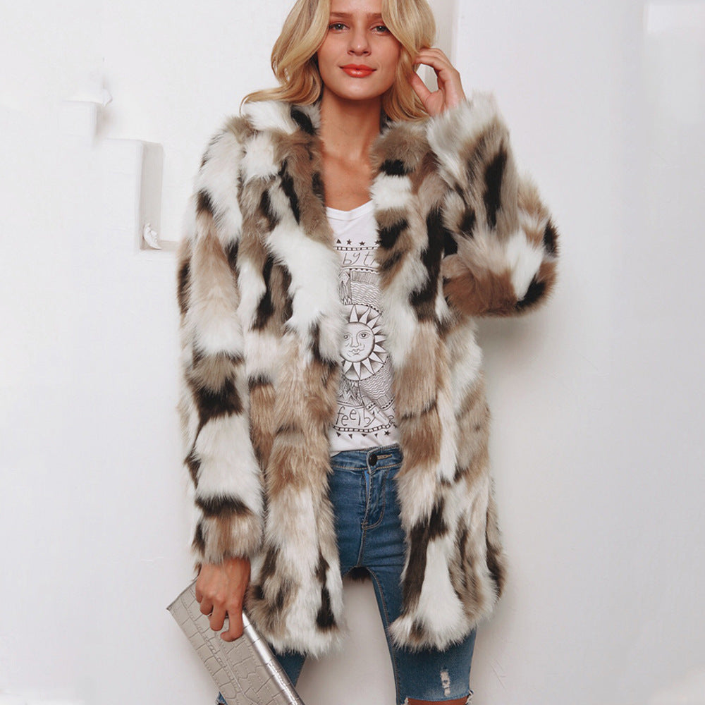 Woman wearing a patterned fur coat over a graphic t-shirt and jeans on a white background