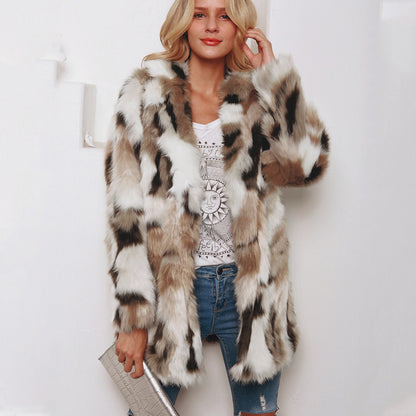 Woman wearing a patterned fur coat over a graphic t-shirt and jeans on a white background